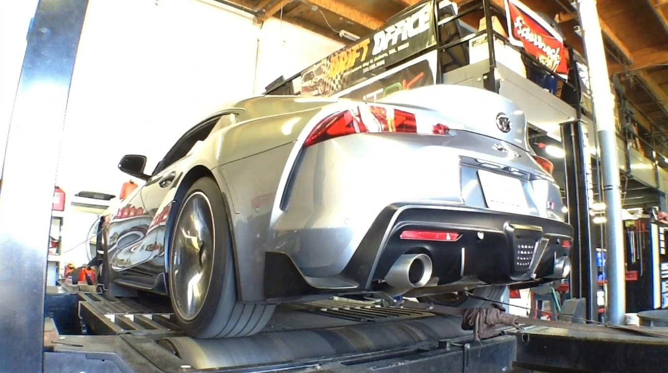 Drift Office shop exterior with a row of tuned Supra, BRZ and WRX STI